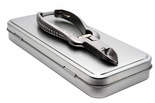 Metallic nail nipper in a tin box on a white background